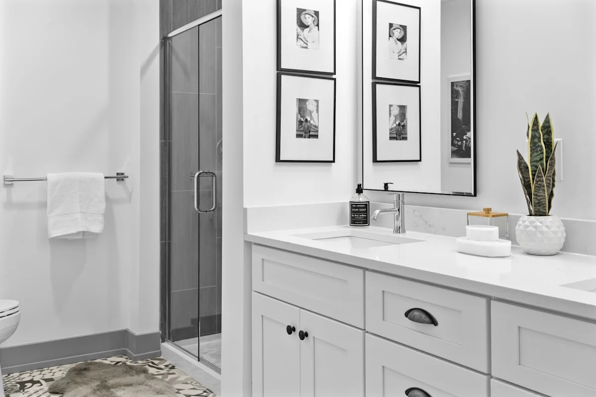 A bathroom with a white toilet, a sink, and a mirror. 