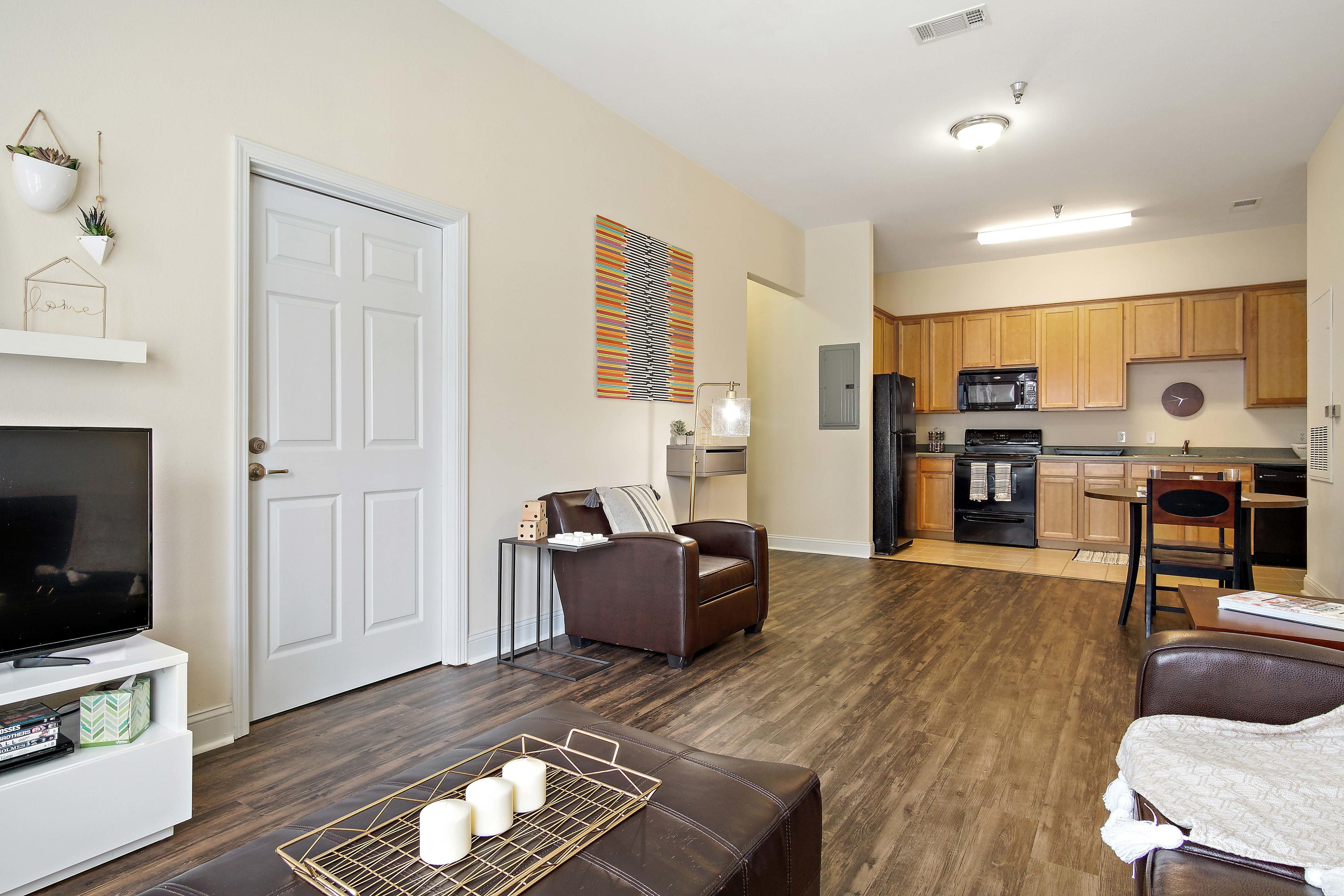 Open concept living with kitchen, dining area, and living room. Central House on Stadium Apartments Mobile (251)272-4710