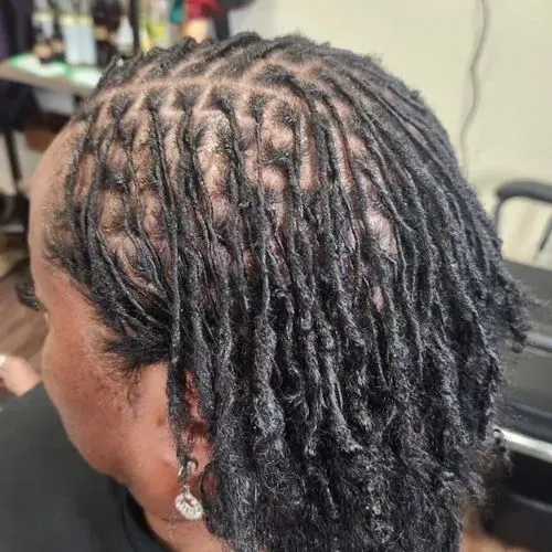Neatly retwisted mature locs with clean scalp parting and consistent sections, highlighting professi 