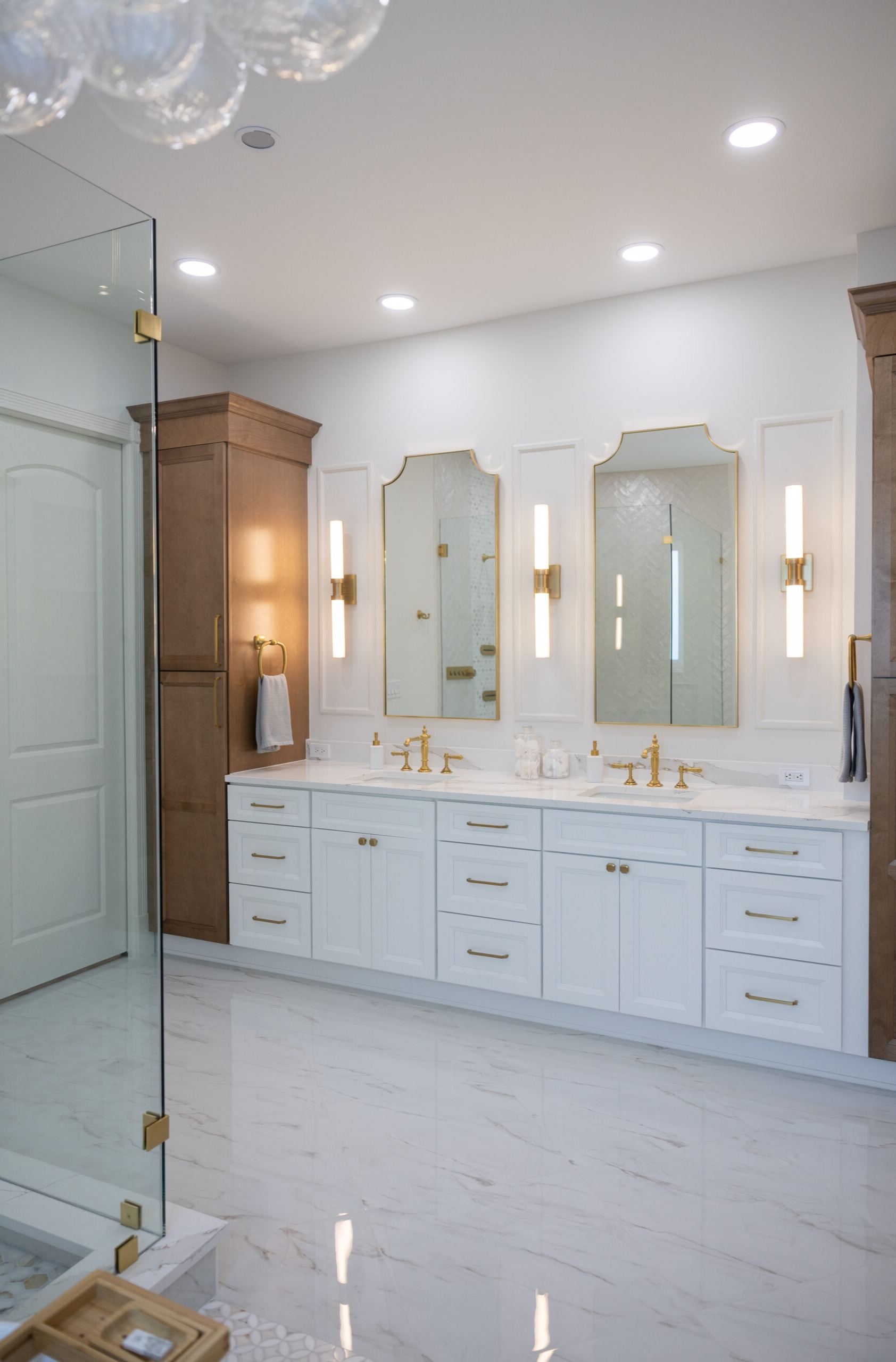 Bathroom remodel featuring a double vanity with premium stone countertops by Coastal Pro Construction in Jensen Beach, FL