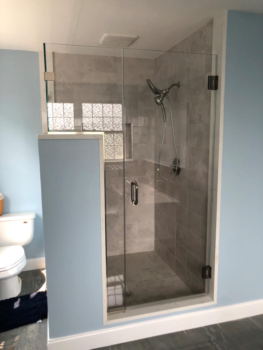 Our handyman crew removed an old jacuzzi and installed a new walk-in shower, custom tile, as well as a custom glass door in Amesbury, MA.
