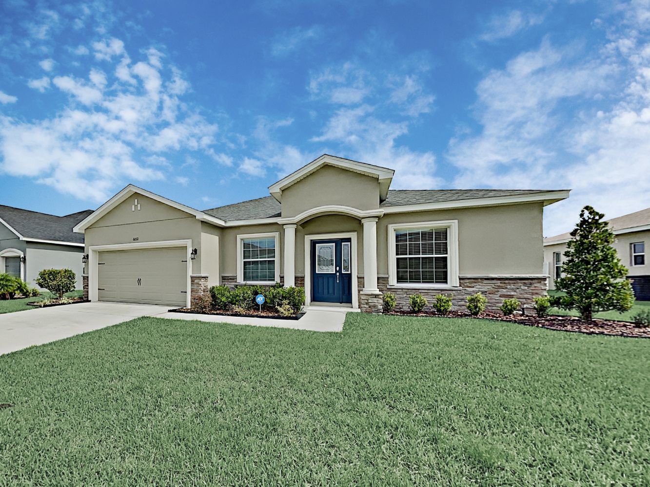 Beautiful home with a two-car garage and large lawn at Invitation Homes Tampa.