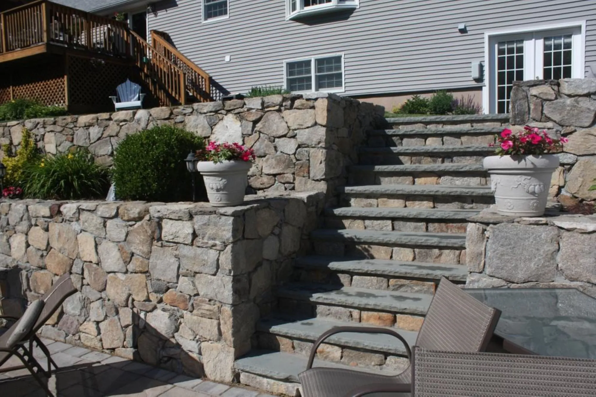 Steps with wall stone and paver patio - Steps project by General Masonry LLC.