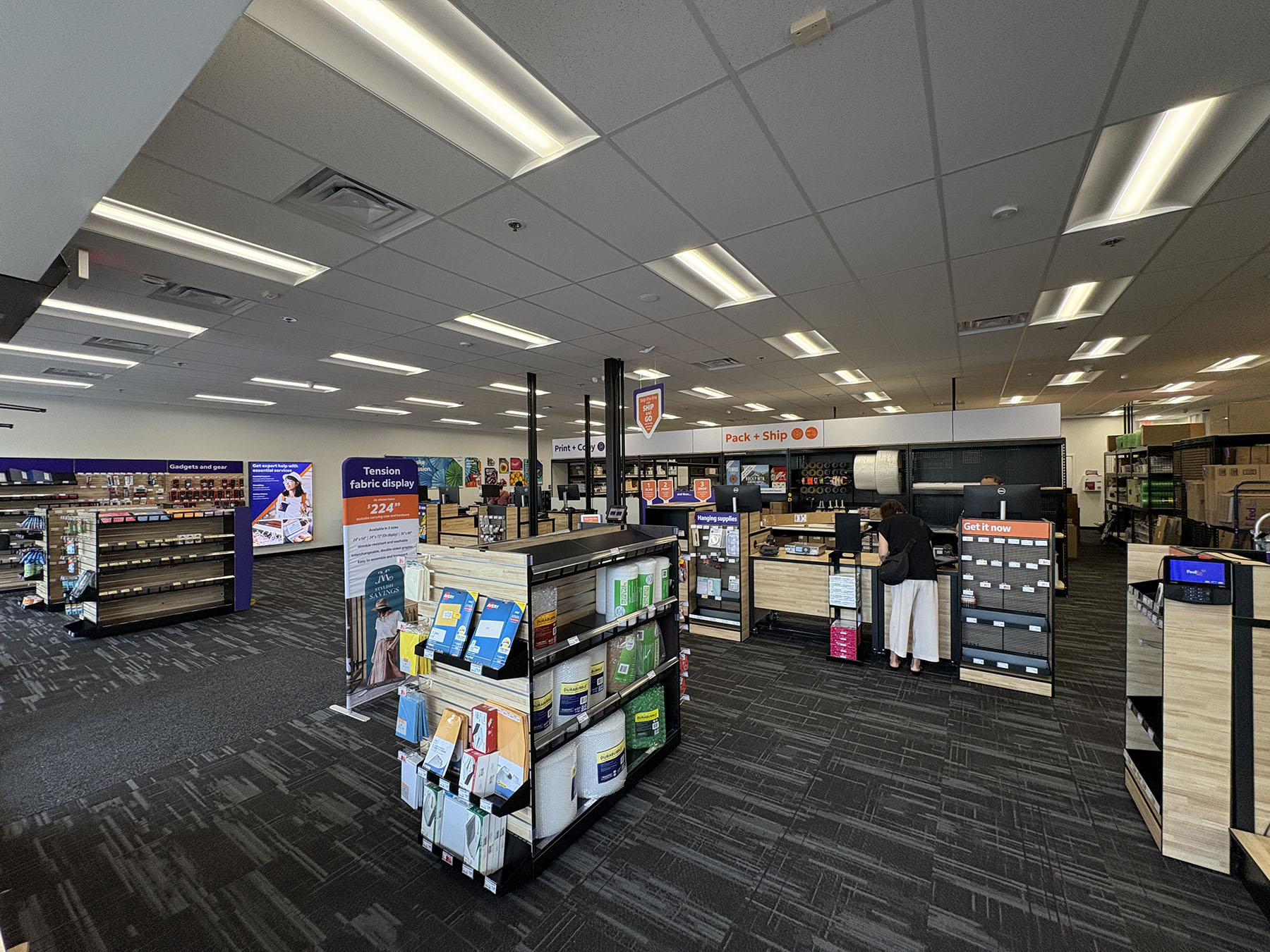 Full Store Interior View &ndash; Open layout of FedEx Office Beaverton location with printing equipment, pack and ship area, and retail displays.