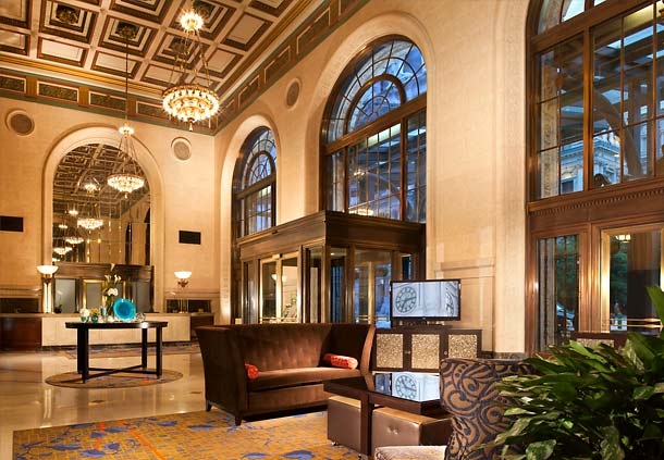 The lobby at the Courtyard Philadelphia Downtown calls back to 1926 grandeur with polished stone and coffered plaster ceiling.