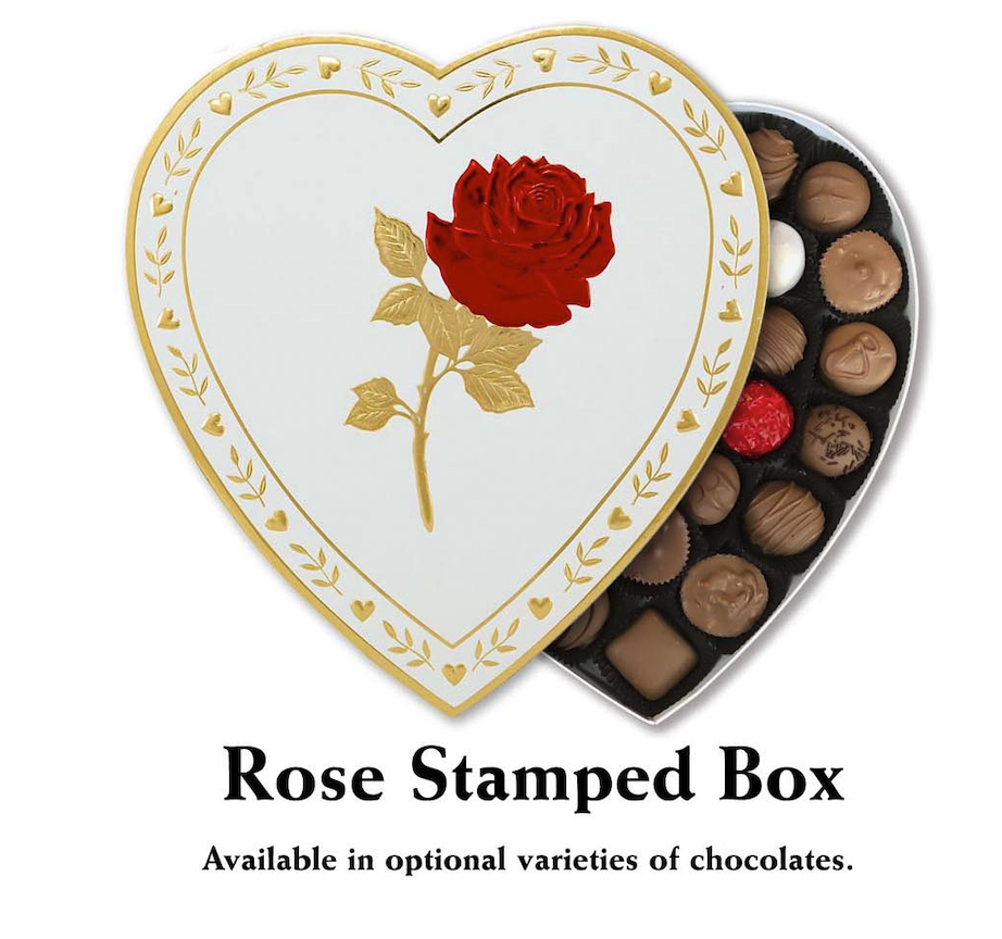 A Valentine's Day-themed heart-shaped box from Florence's Exquisite Chocolates in Rexburg, ID. The box features a beautifully embossed red rose and gold leaves on the lid, surrounded by a gold heart and leaf border. Inside, the box contains a variety of chocolates, including milk chocolate, dark chocolate, and assorted filled chocolates. This elegant and romantic packaging makes it an ideal gift for Valentine's Day, showcasing Florence's commitment to quality and presentation.