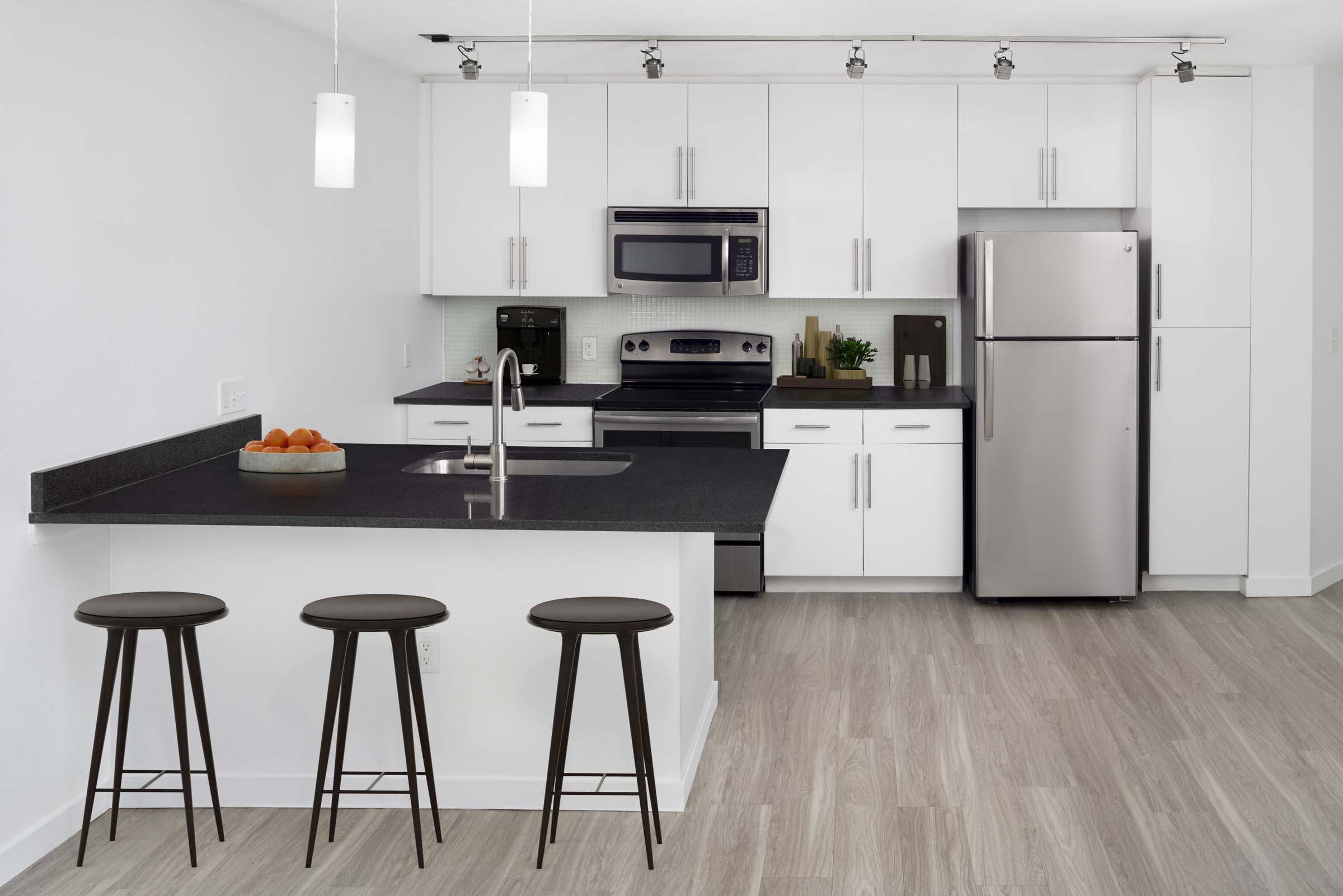 Kitchen with modern interior finishes at Camden Thornton Park apartments in Orlando, FL