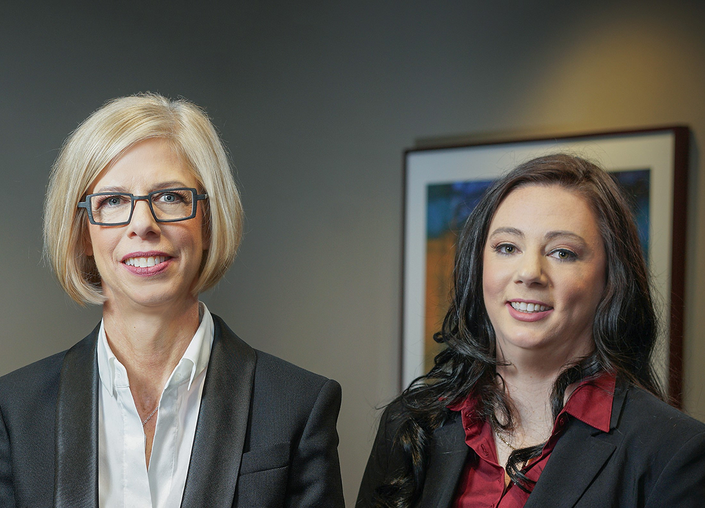 Elyse Clements and Tamara Warriner standing side by side in their office.