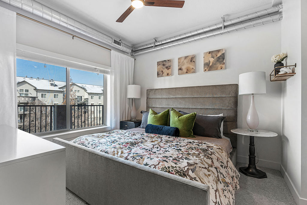 a bedroom with a bed and a window