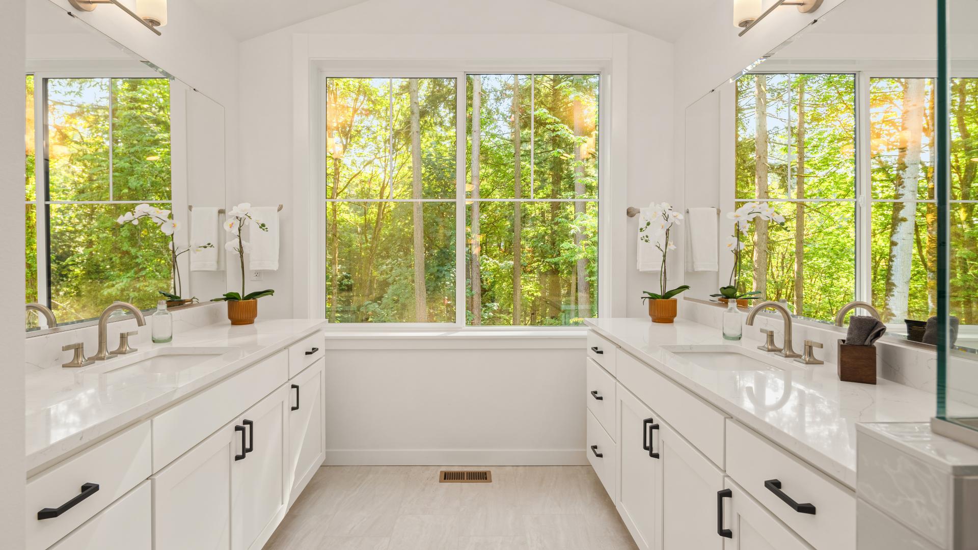 Primary bathroom with vaulted ceiling and greenbelt views