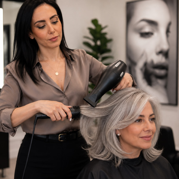 Master Stylist Kimia completes a customized women's haircut and professional blowout at Avissa Salon 