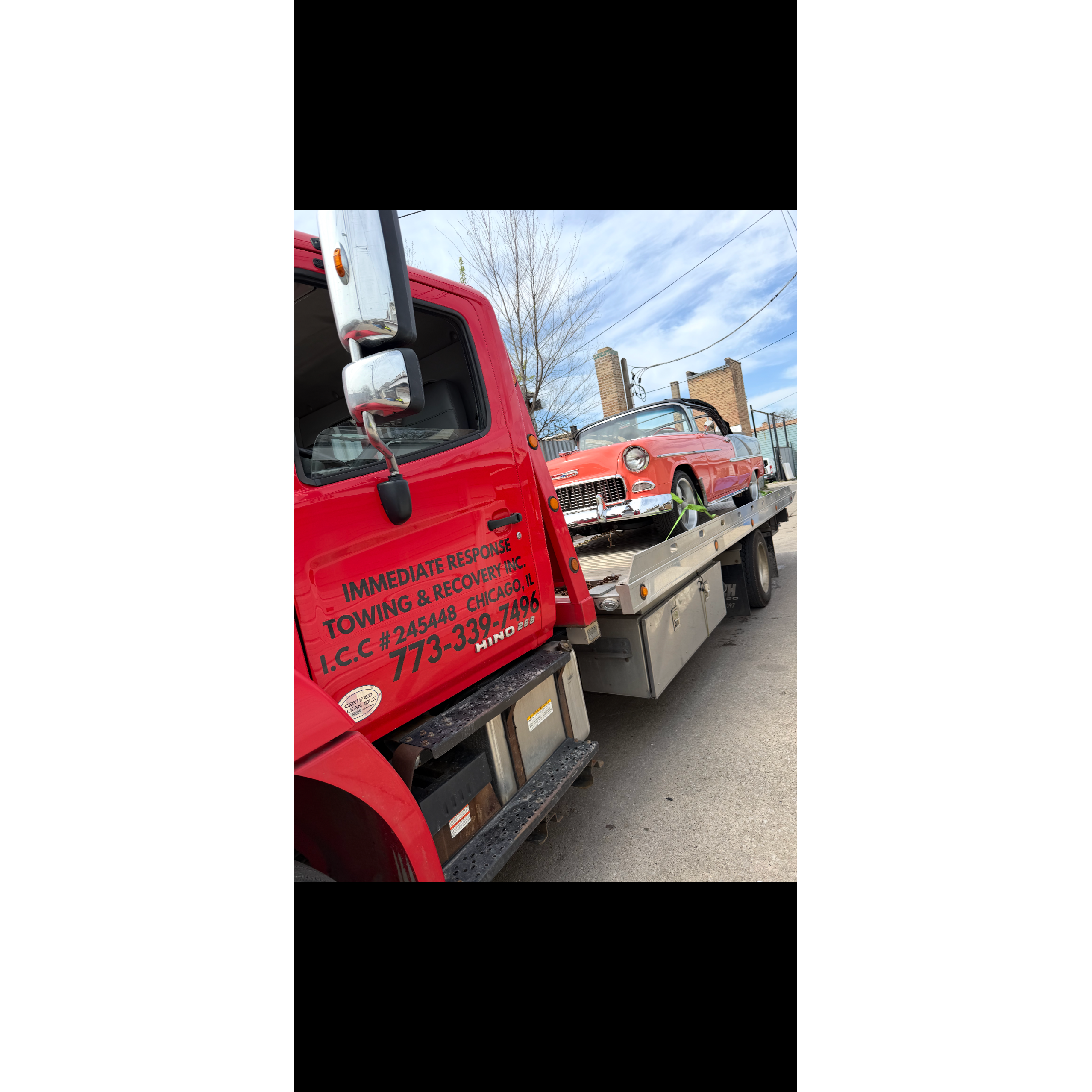 Immediate Response Towing & Recovery Chicago flatbed tow truck transporting a vehicle inside a parki 