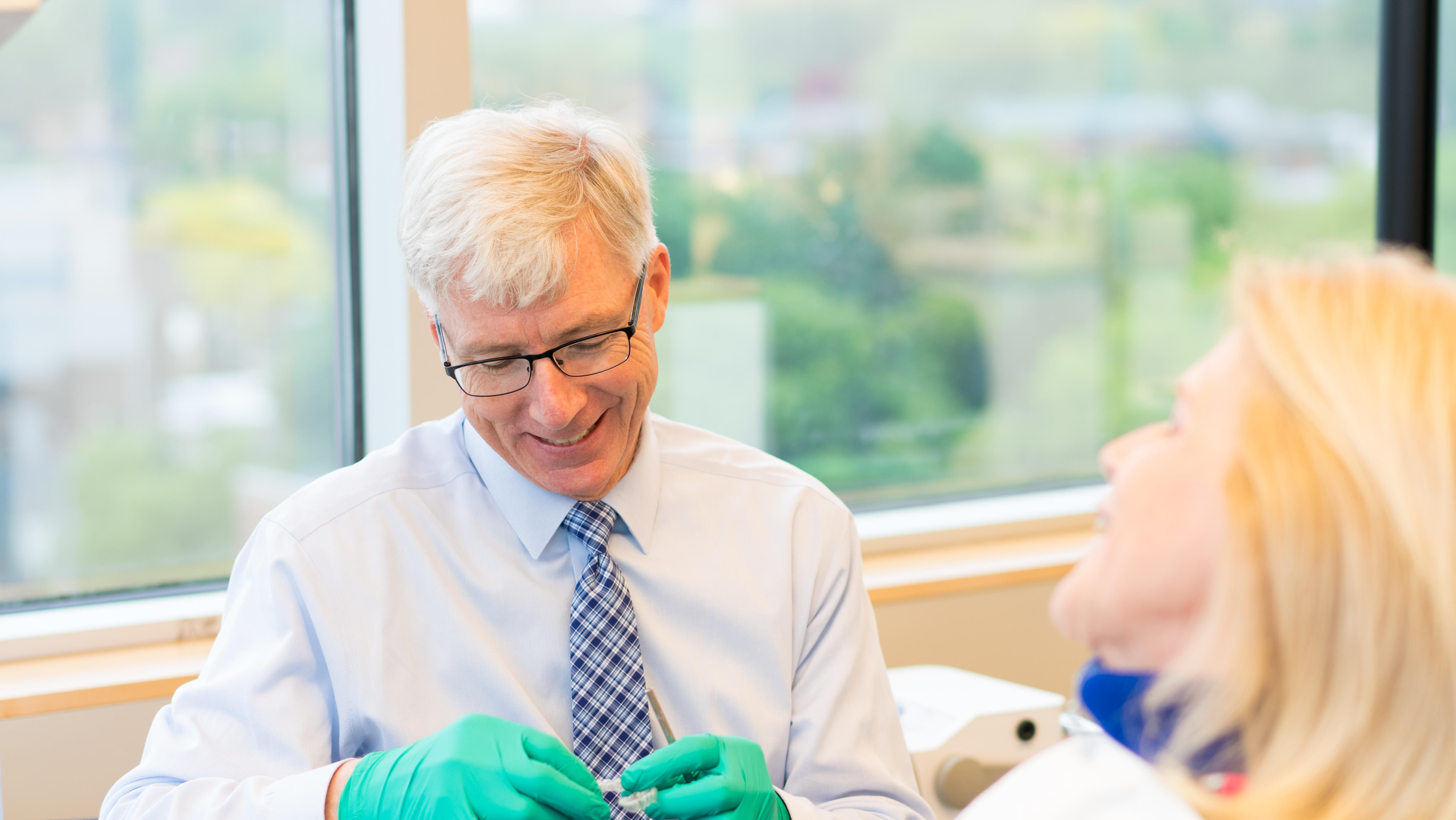 Dr. Brendan Cooney smiling at Patient in Troy, Ny orthodontic office.