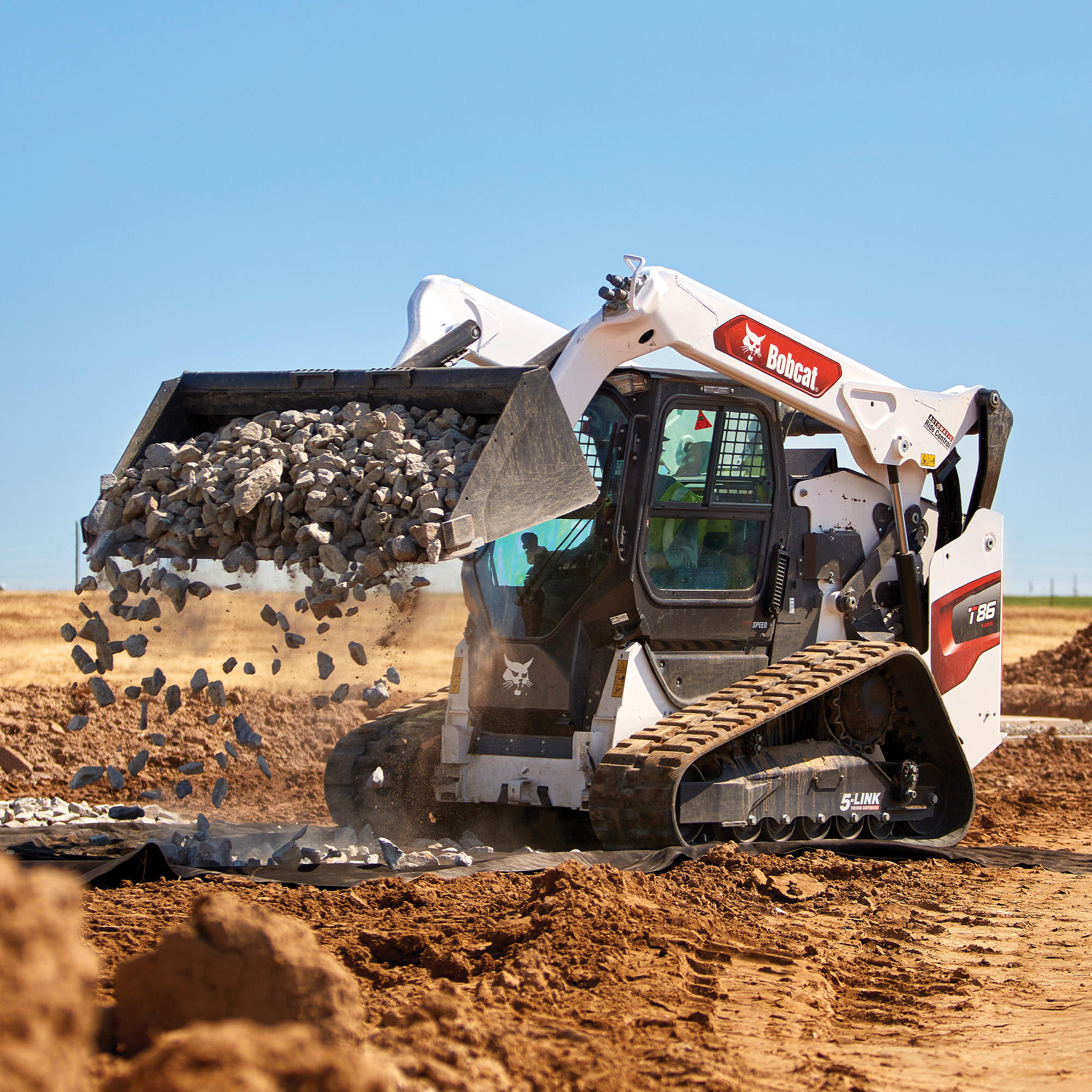 Bobcat T86 dumping and spreading rock with bucket Bobcat of Fort McMurray Fort Mcmurray (780)714-9200