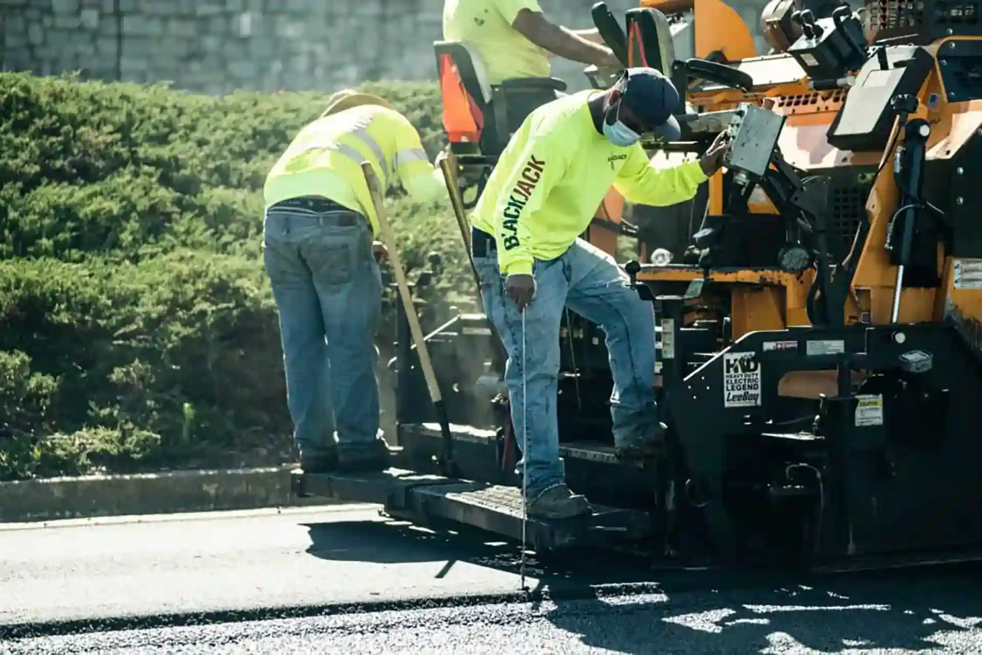 Blackjack Paving crew performing Asphalt paving on a street