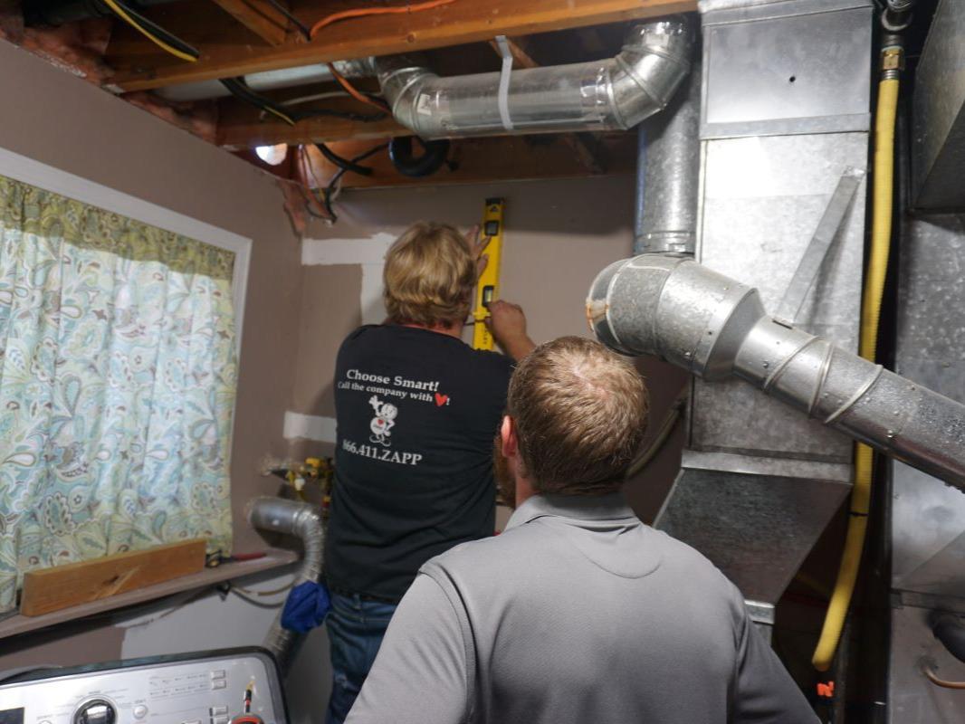 Plumber prepares a home for tankless water heater installation