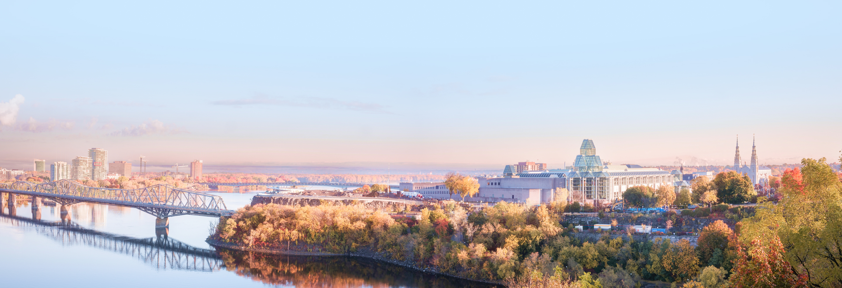 An aerial view of the Parliament Buildings in Ottawa at sunset.