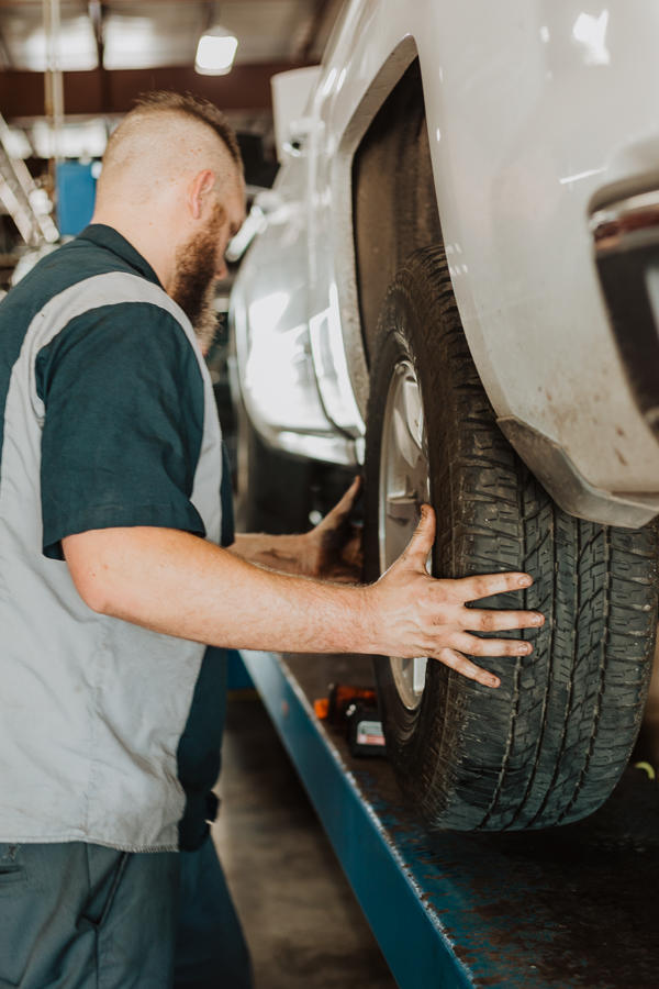 auto mechanic replacing a tire on a truck