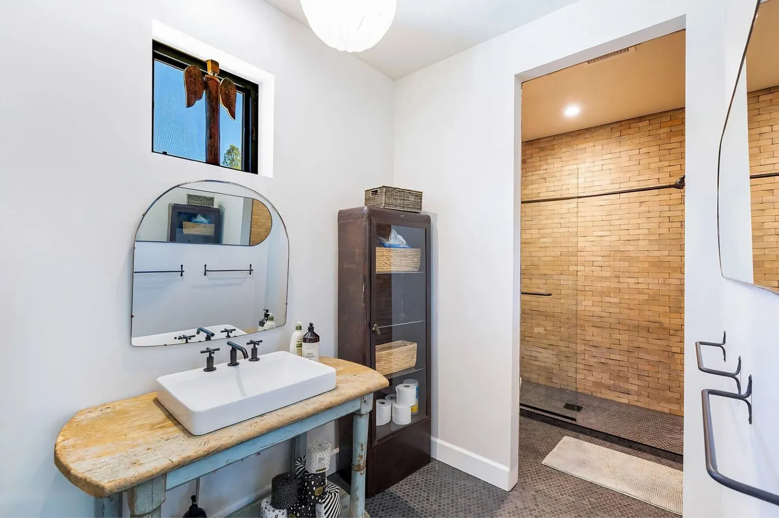 Elegant bathroom remodel featuring a custom vanity, walk-in shower, decorative mirror, and modern fixtures. Designed to provide functionality, comfort, and timeless visual appeal.