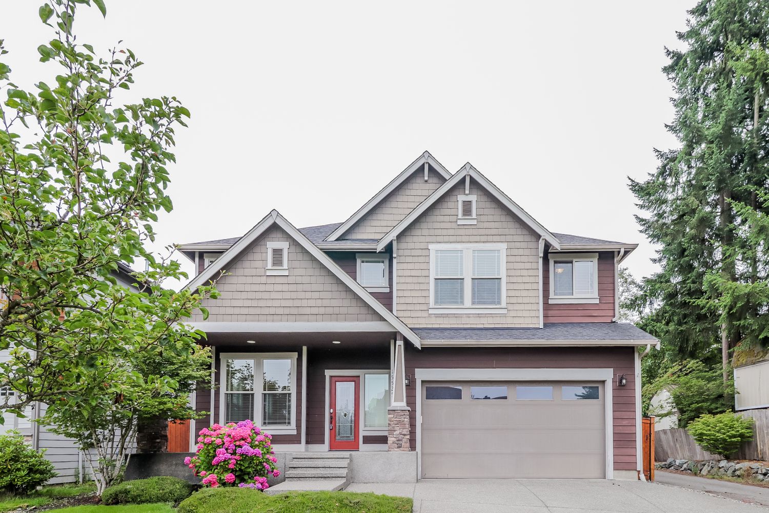 Front of home with two-car garage and covered porch at Invitation Homes Seattle.