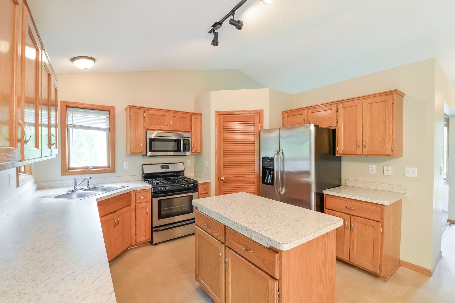 Spacious kitchen with stainless steel appliances and prepping island at Invitation Homes Minneapolis.