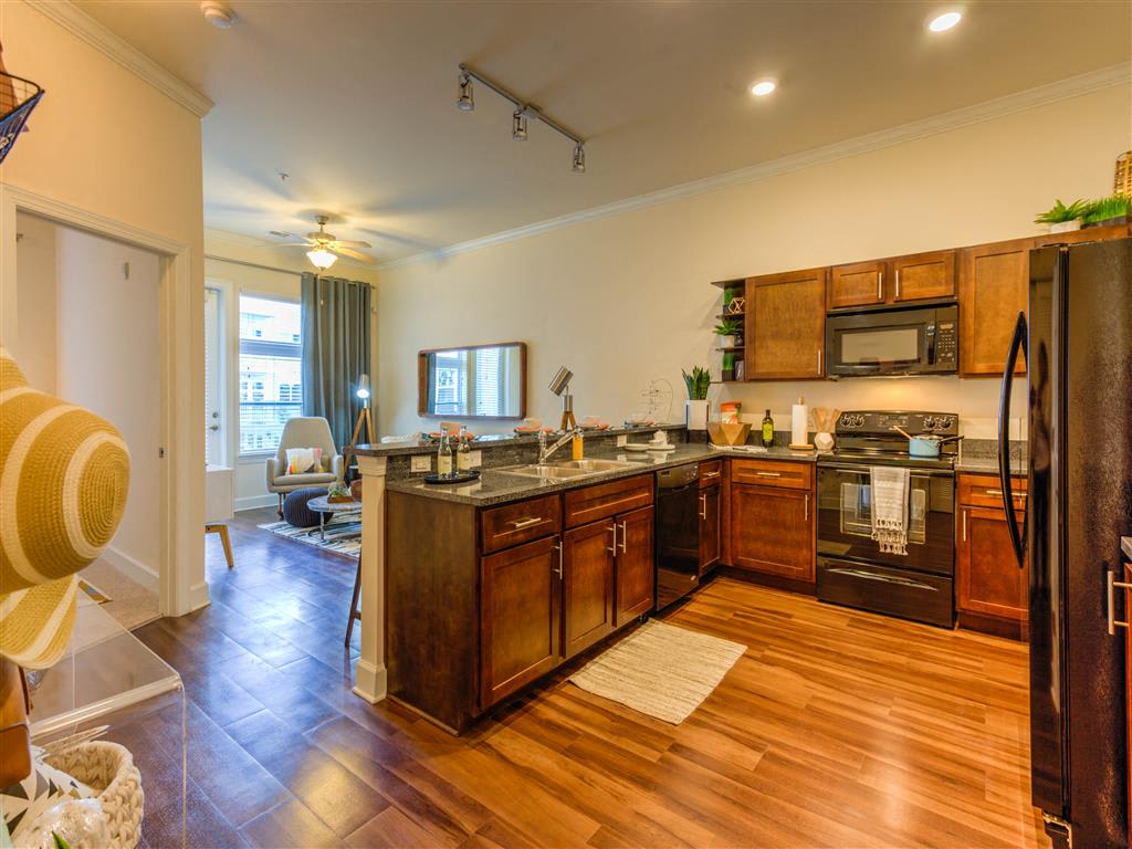 kitchen with dark wood cabinetry and hardwood floors
