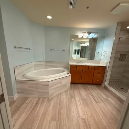Finished tiled shower and bathroom interior with recessed lighting. 