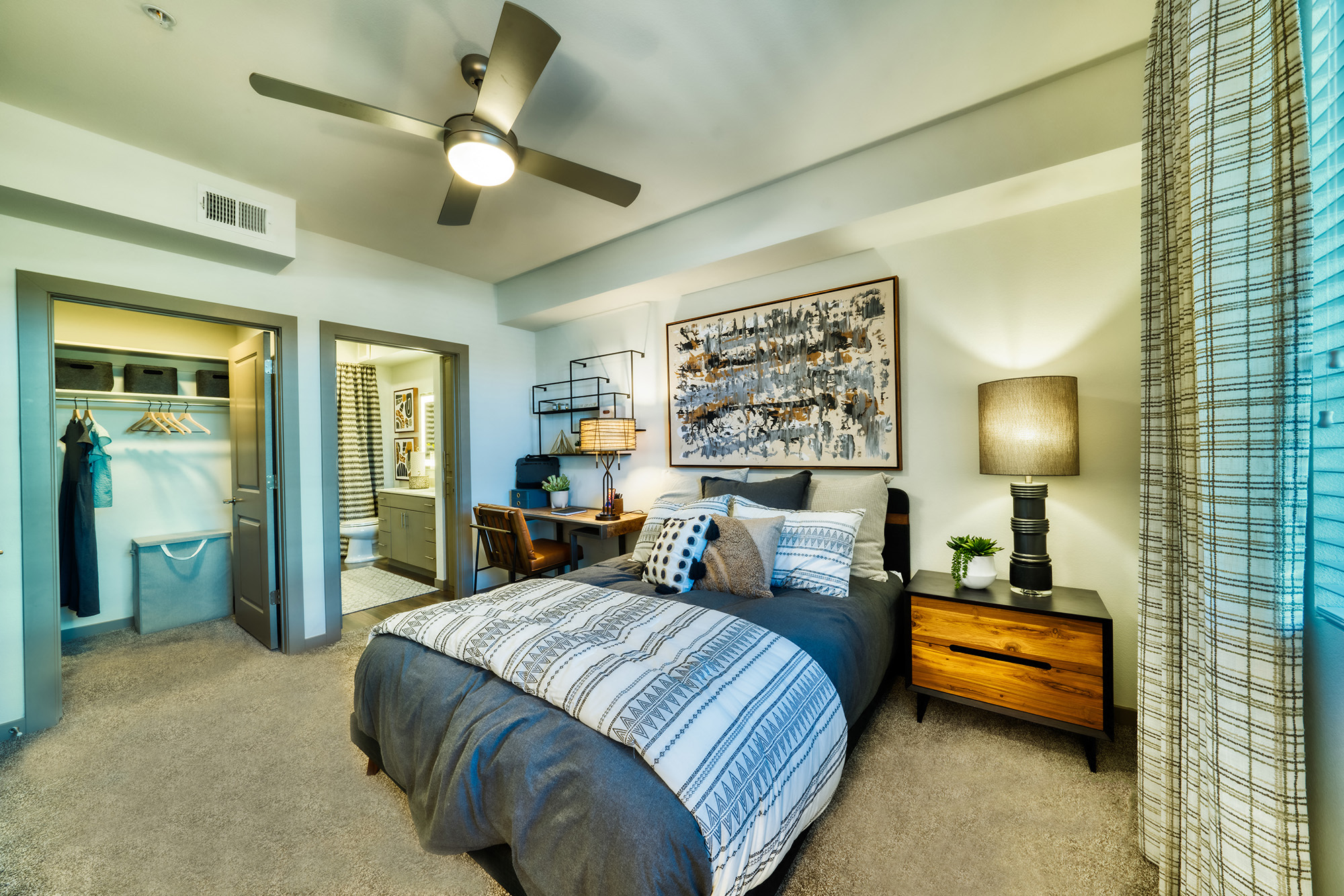 a bedroom with a bed and a ceiling fan