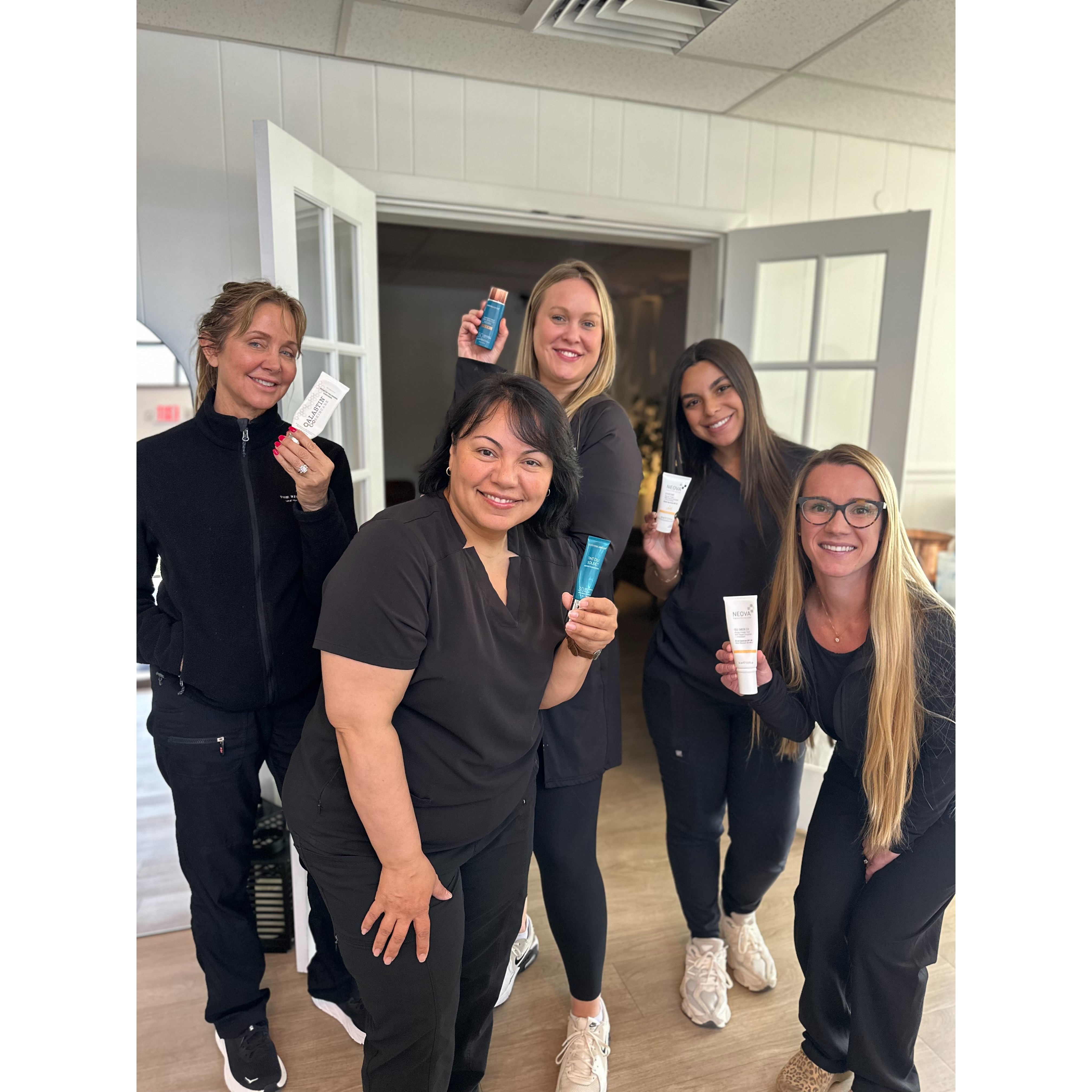 Staff photo holding sunscreen products that Viva Vitality sells.