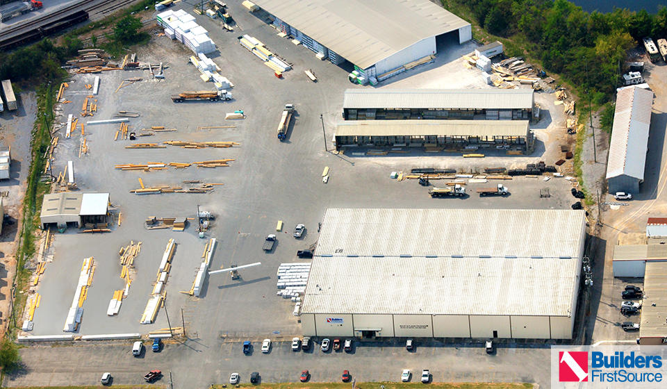 Building materials supplier Builders FirstSource's forklift is moving wood roof trusses.