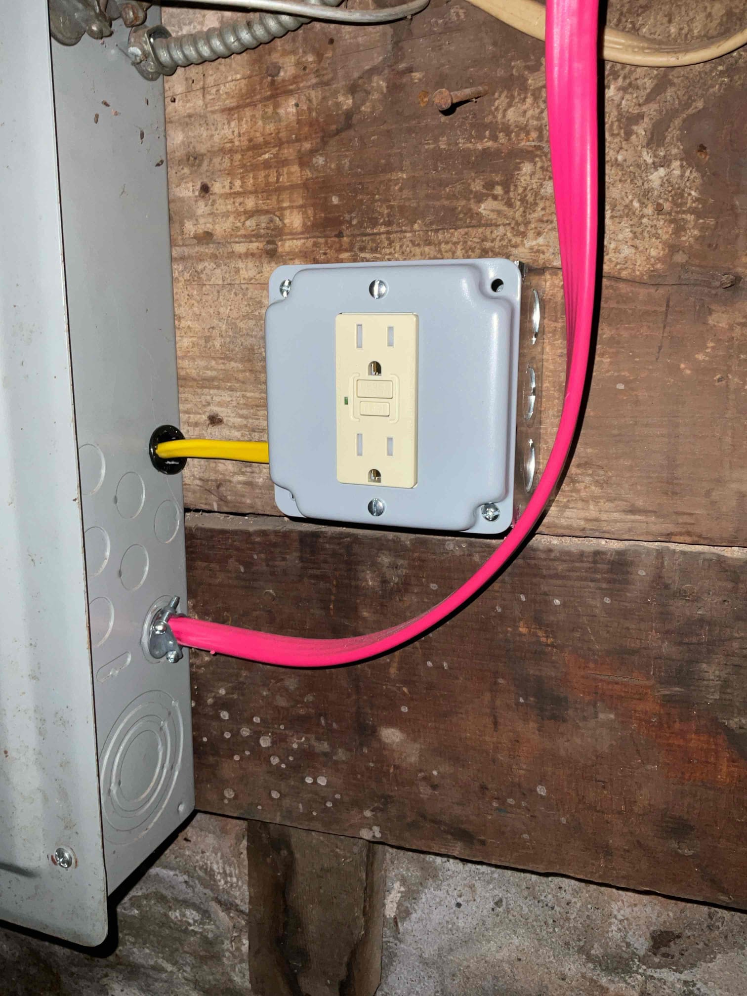 Thomas Edison Electric installed this GFCI-protected outlet on a surface-mount box adjacent to the electrical panel in a Norristown, PA basement. The ground-fault protection is a code requirement in below-grade spaces, keeping the homeowner safe from electrical shock.