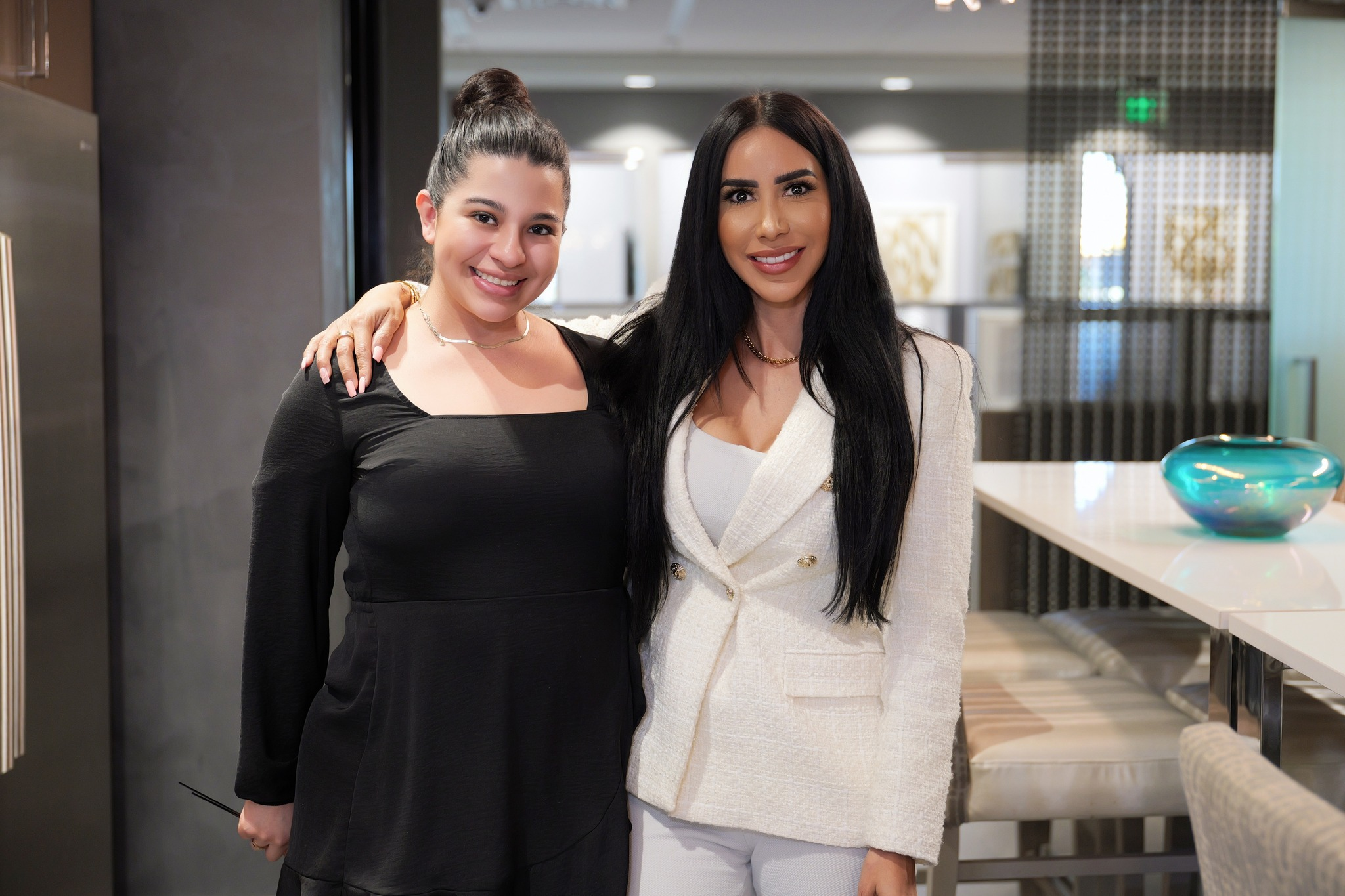 Naqvi women employees smiling for a picture in the office