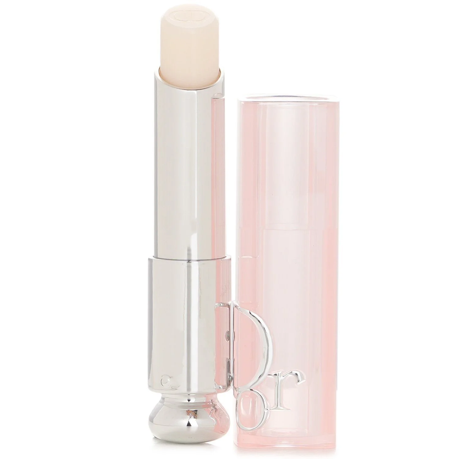 A close-up studio shot shows an open tube of Dior Addict Lip Glow balm, with the creamy, light-colored balm at the top and the reflective silver applicator. Next to it is its translucent pink cap, with the brand's "CD" logo embossed on the side.