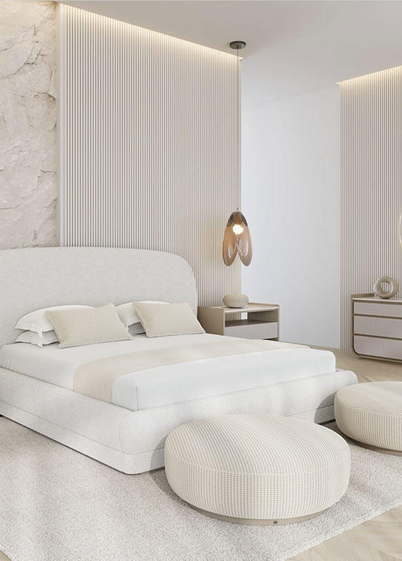An elegant and modern bedroom with a soft upholstered bed and round ottmans.