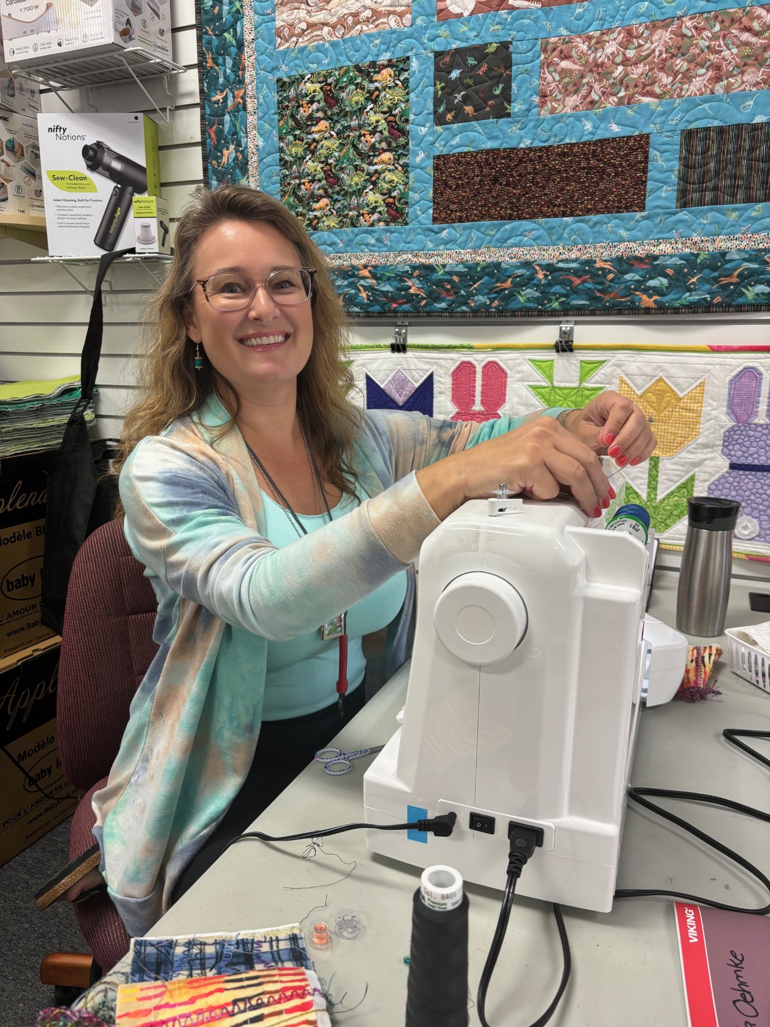 A quilter prepares her sewing machine during a Decorative Stitch class, exploring creative stitch techniques and quilting skills in a welcoming, hands-on learning environment.