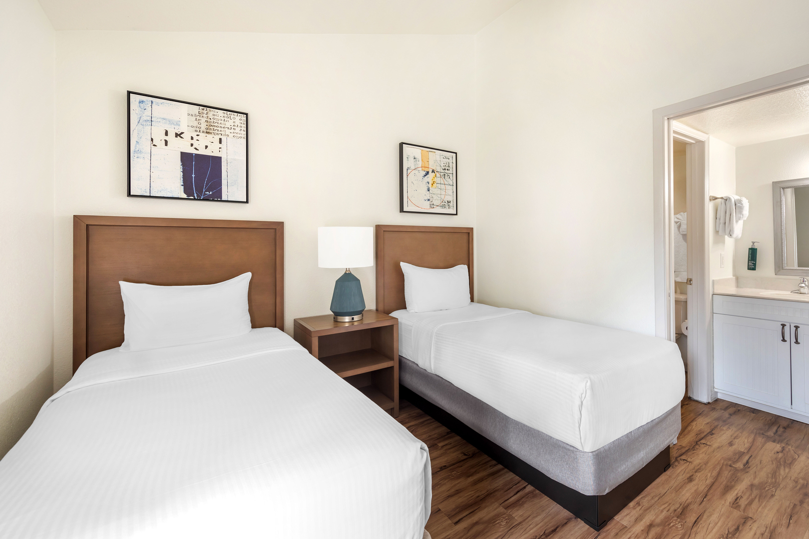 The interior of a 2-Bedroom Suite (Sleeps 6) at Bryan's Spanish Cove. Two beds are featured in this room.