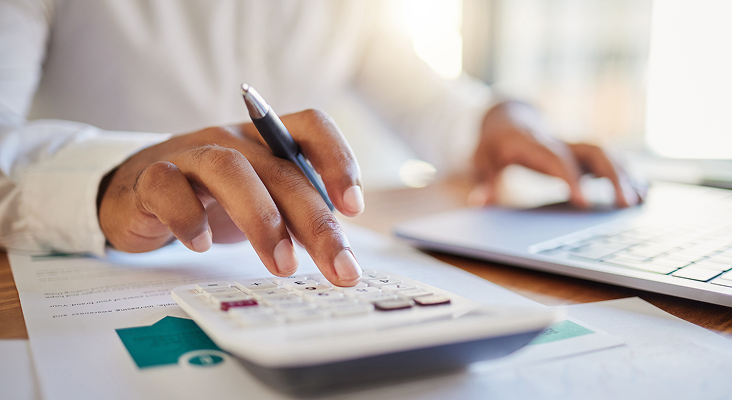 Close-up shot of a person using a calculator.