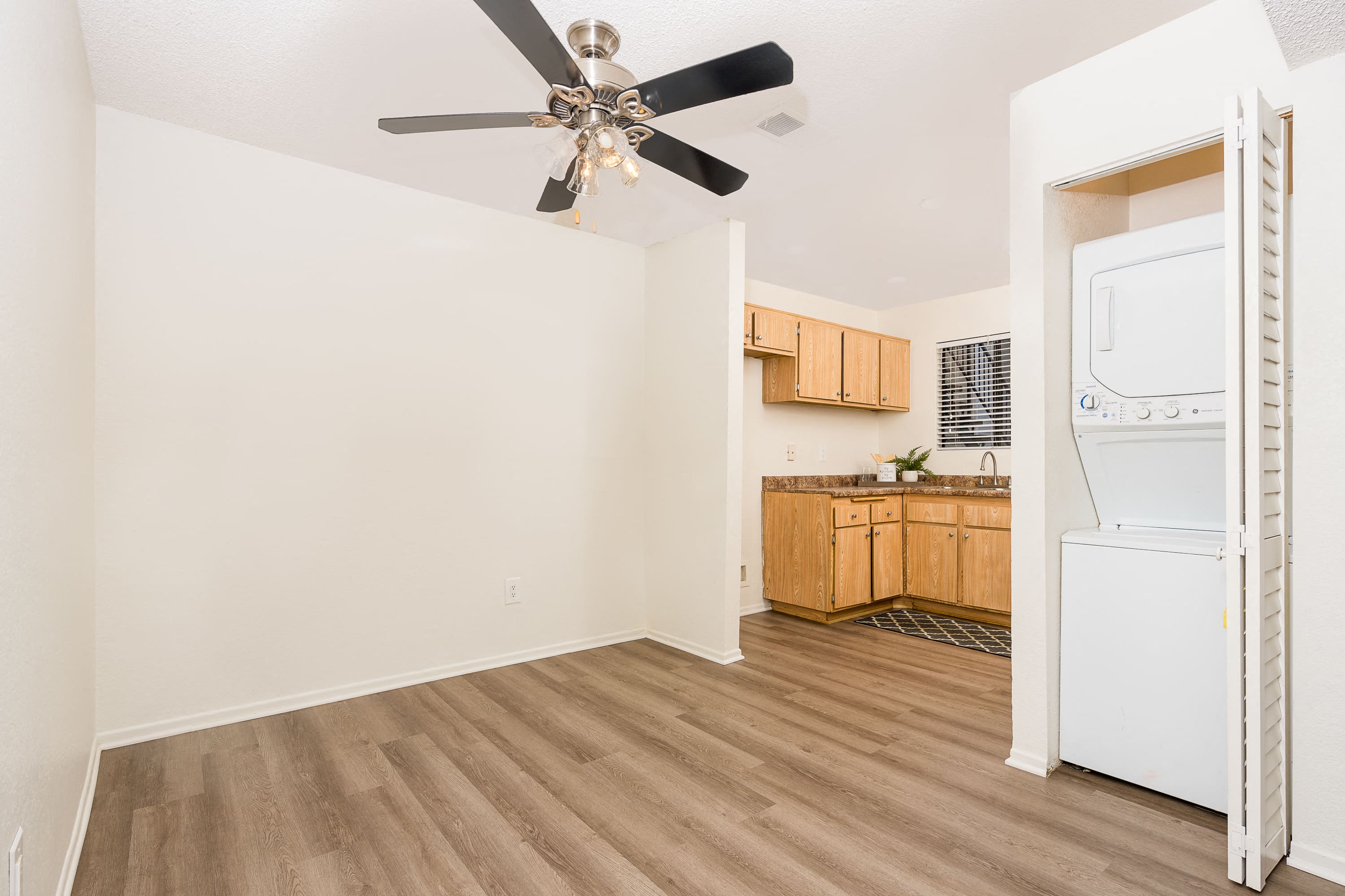 Dining area with ceiling fan and in unit washer and dryer