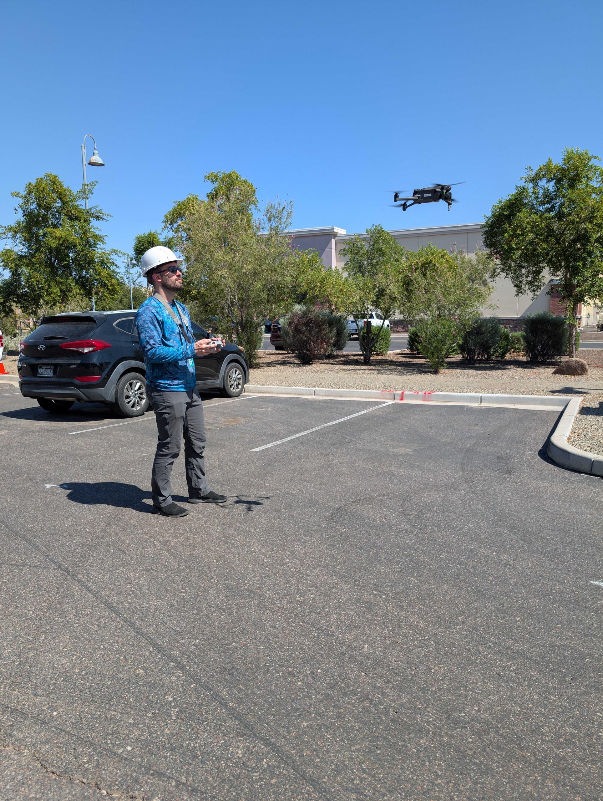 Jack & Bean co-founder David Raines flying a drone on a job site. 