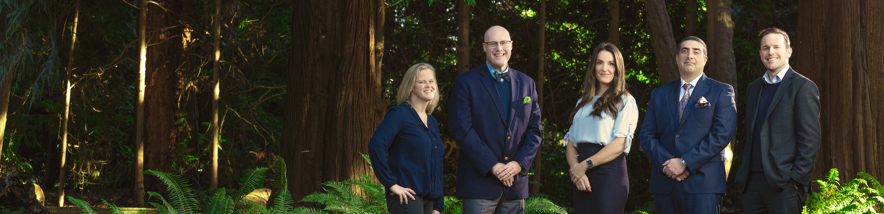The Lonsdale, Nozari & Andrews Private Wealth team standing side by side in a forest.