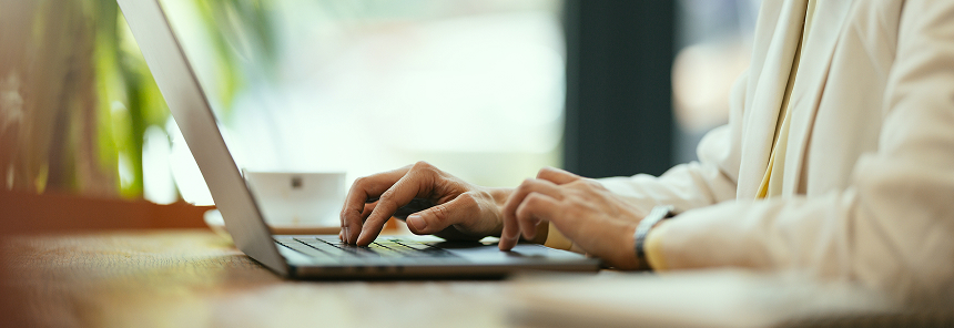 Hands typing on a keyboard.