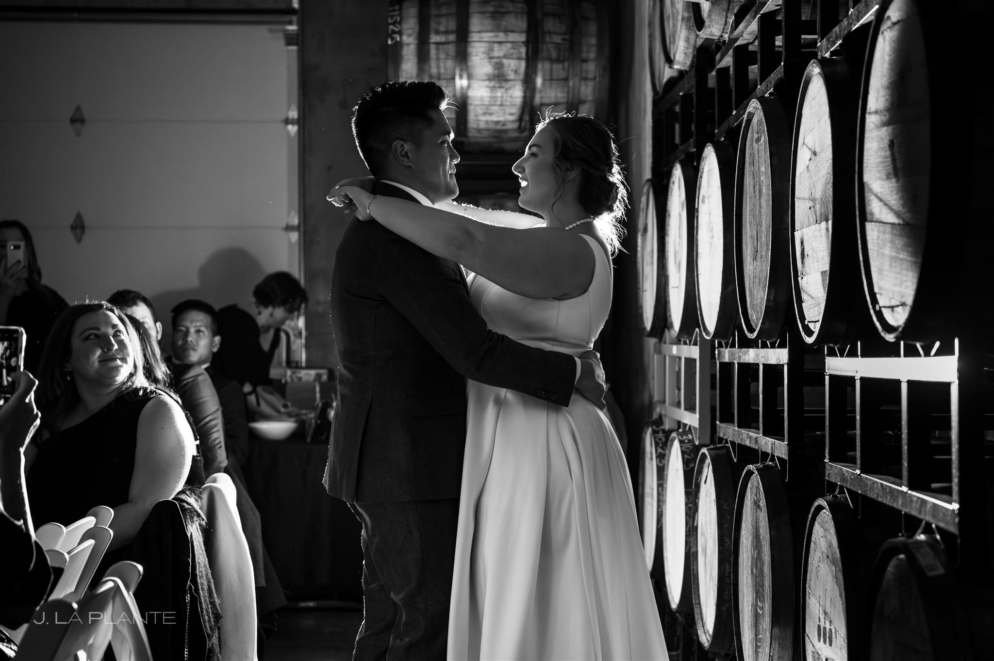 A wedding reception at Acreage Ciders featuring a couple's first dance surrounded by cider barrels and guests in an intimate event setting.