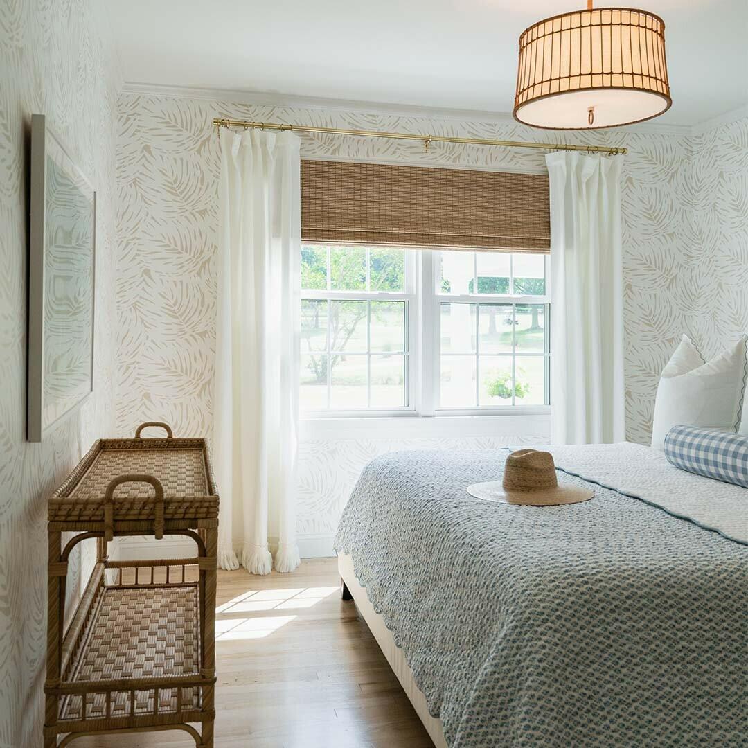 This bedroom is a perfect example of how an all-natural woven wood can complement any space! This customer paired their rattan furniture and statement wallpaper with a warm woven wood shade to create a clean and inviting look.