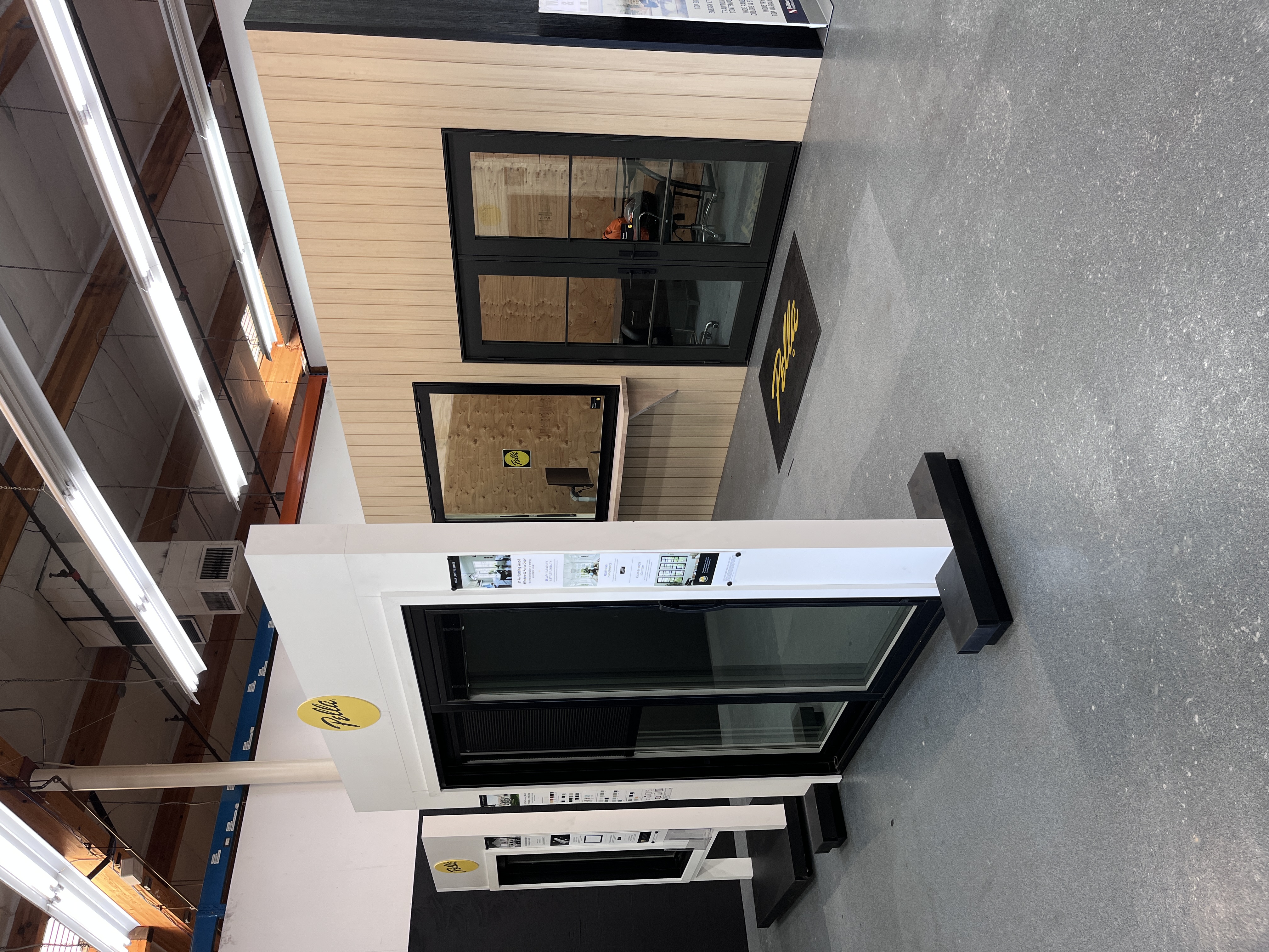 Pella showroom display at Builders FirstSource Thousand Oaks, CA, featuring sliding glass doors and a mock office space with French doors.