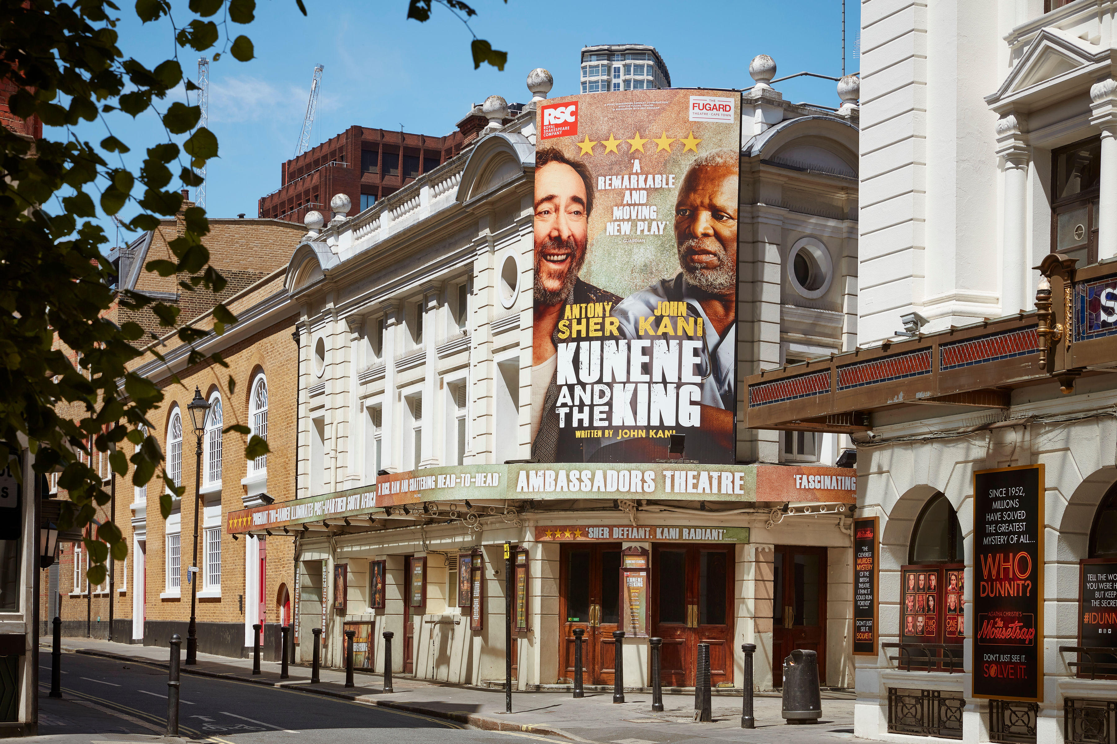The front of Ambassadors Theatre seen from a distance