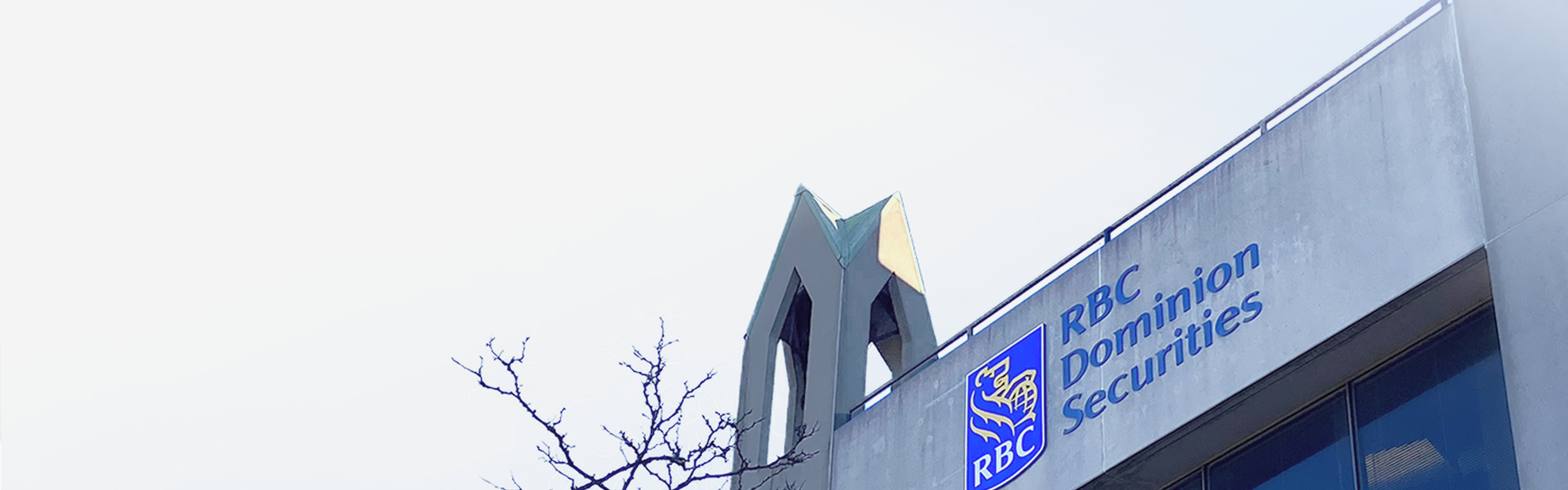 Close-up shot of an RBC Dominion Securities logo on the side of a building.