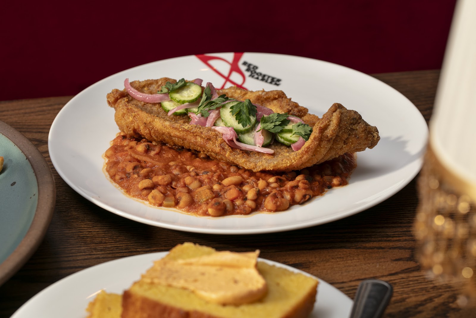 Fried catfish at Red Rooster Harlem, served with a Southern side. Located in Harlem.