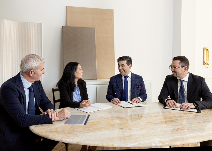 The Naman Private Wealth team meeting with two partners.