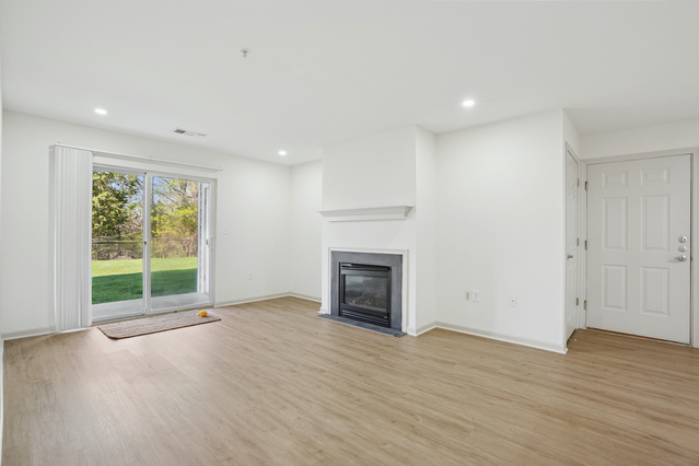The Estates - Spacious Unfurnished Living Room with Fireplace
