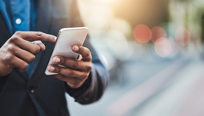 Close-up of a person scrolling on their cellphone.